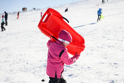 Rear view of child on snowy field