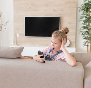 Girl with mouth open looking at smart phone