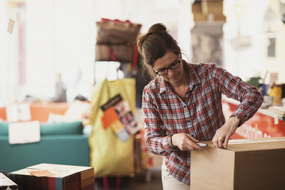 Owner unpacking box at store