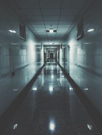 Empty illuminated corridor in building