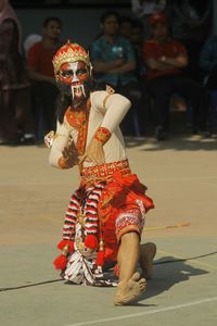 Full length of senior man in traditional clothing during festival