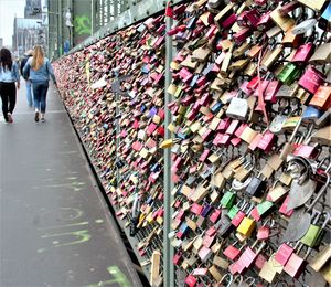 Padlocks on railing of bridge