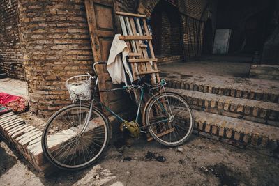 Bicycle parked by wall