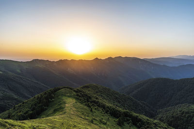 Scenic view of mountains against sky during sunset