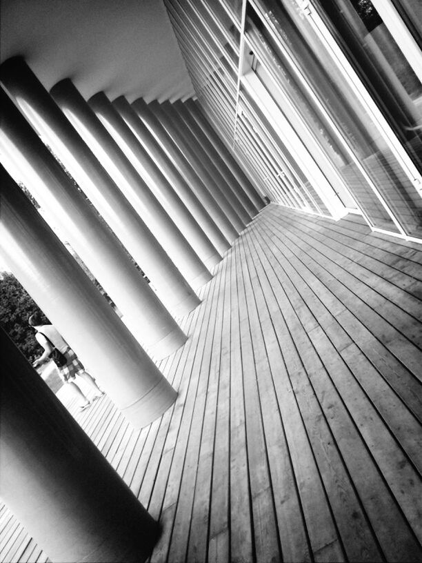 indoors, in a row, repetition, high angle view, steps, pattern, steps and staircases, order, wood - material, staircase, low angle view, built structure, railing, no people, modern, arrangement, day, large group of objects, architecture, diminishing perspective