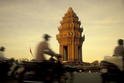 Blurred motion of cathedral against buildings at sunset