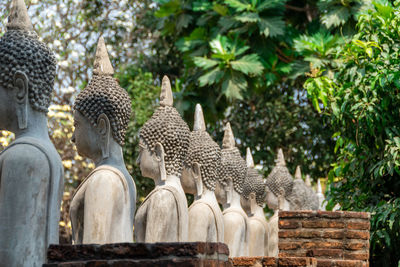 Statue of buddha against trees