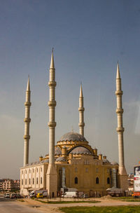 Minarets of mosque of manavgat against blue sky