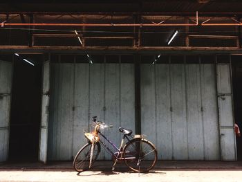 Bicycle parked against wall in abandoned building