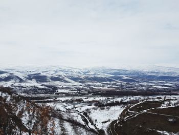 Scenic view of snow covered mountains against sky