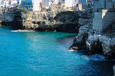 Scenic view of sea by buildings in city