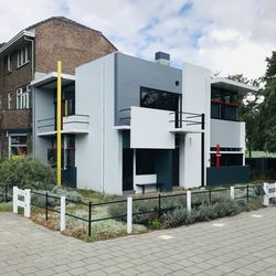 Exterior of houses by building against sky