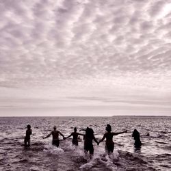 Scenic view of sea against cloudy sky