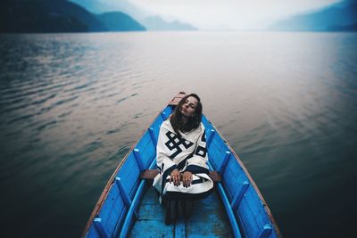 Portrait of a young woman sitting in water