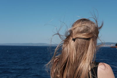 Portrait of woman by sea against sky