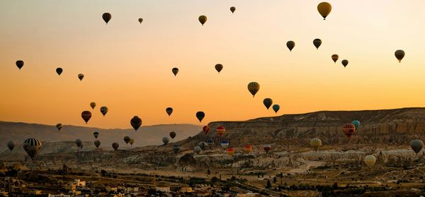 Hot air balloons flying over landscape