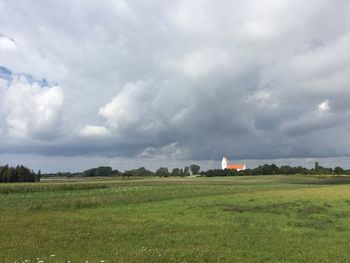 View of fields against cloudy sky