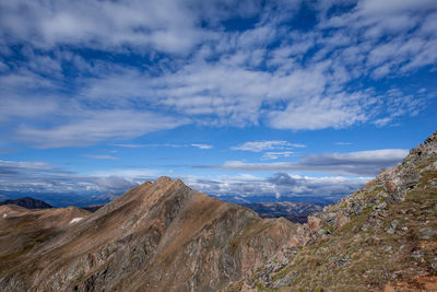 Scenic view of mountains against blue sky