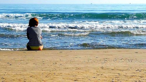 Rear view of woman on beach