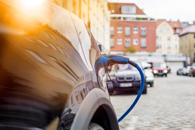 Close-up of car refueling on city street