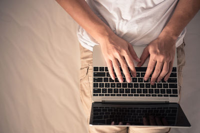 Midsection of man using mobile phone