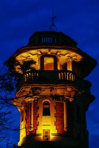 Low angle view of illuminated building against sky at dusk