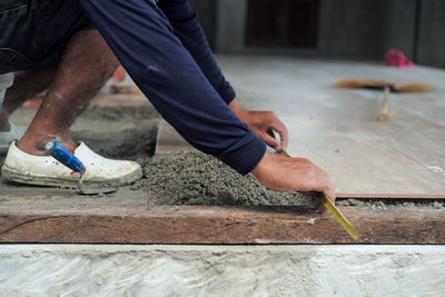 Low section of man working on wood