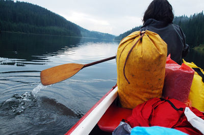 Rear view of man in boat on lake