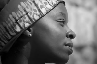 Close-up portrait of young woman looking away