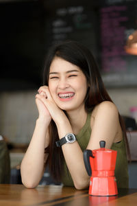 Portrait of smiling female owner at cafe