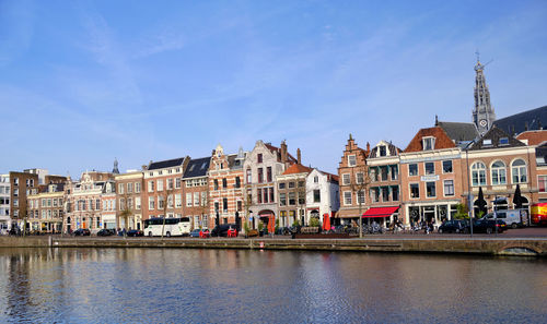 Haarlem, netherlands. traditional dutch houses and cafes lining the river sparne in springtime.