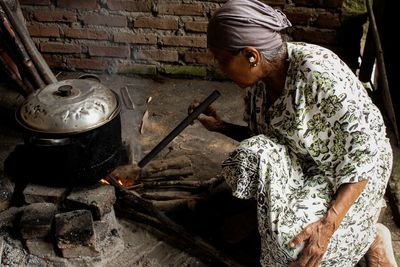 Side view of woman preparing food