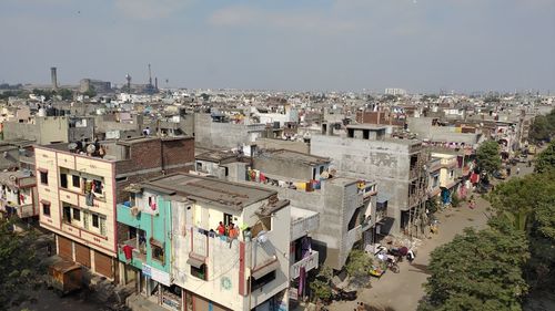 High angle view of buildings in town against sky