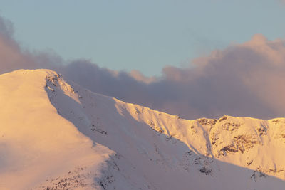 Scenic view of snow covered mountains against sky