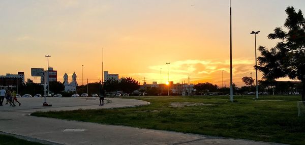 View of street and buildings against sky during sunset