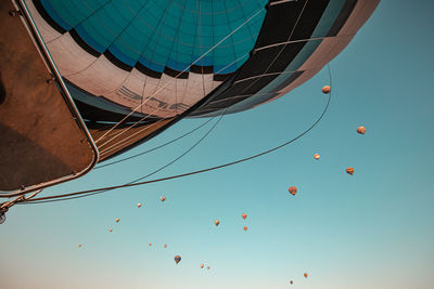 Low angle view of hot air balloons against blue sky