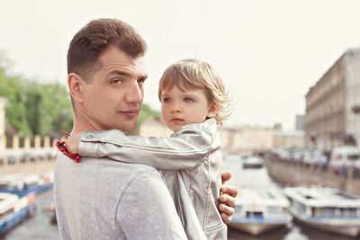 Portrait of mother and son with daughter against clear sky