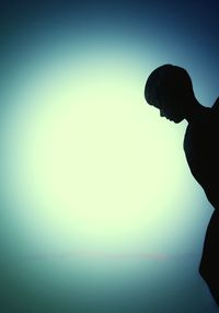 Low angle view of silhouette man against clear sky