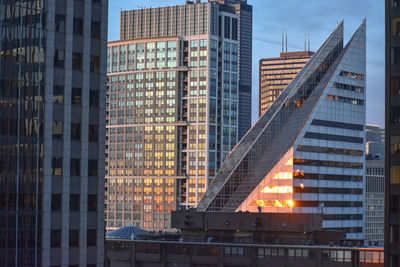 Low angle view of modern buildings against sky in city