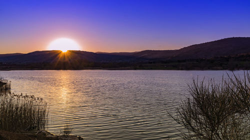 Scenic view of lake against sky during sunset