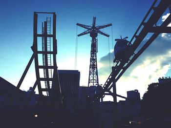 Low angle view of crane against sky