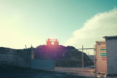 Buildings in city against sky during sunset