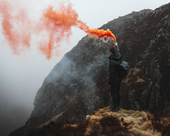 Man with umbrella on mountain