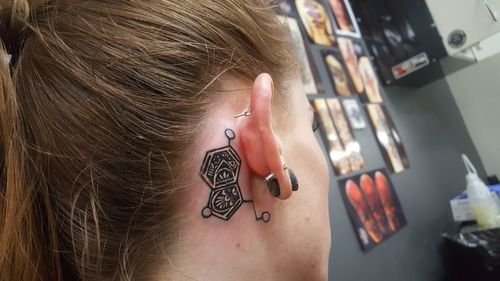 Close-up of woman with tattoo on neck