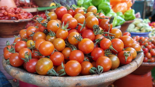 Close-up of tomatoes in basket for sale at market stall