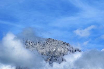 Low angle view of snowcapped mountain against sky