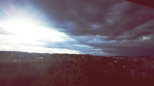 Buildings against cloudy sky