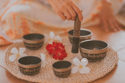 Female hands play meditation on tibetan bowls