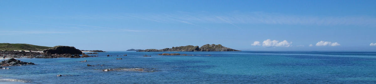 Scenic view of sea against blue sky