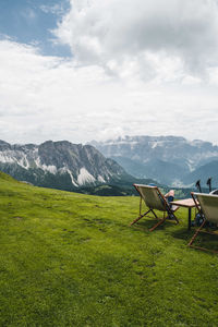 People relaxing on the lounge chairs in the mountains